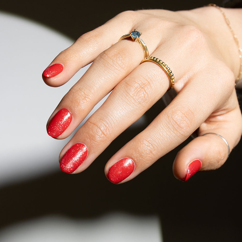 Gelous Shimmer Top Coat on Red Sass gel nail polish - photographed in New Zealand on model